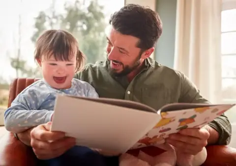Family reading together at home, supported by NDIS plan management